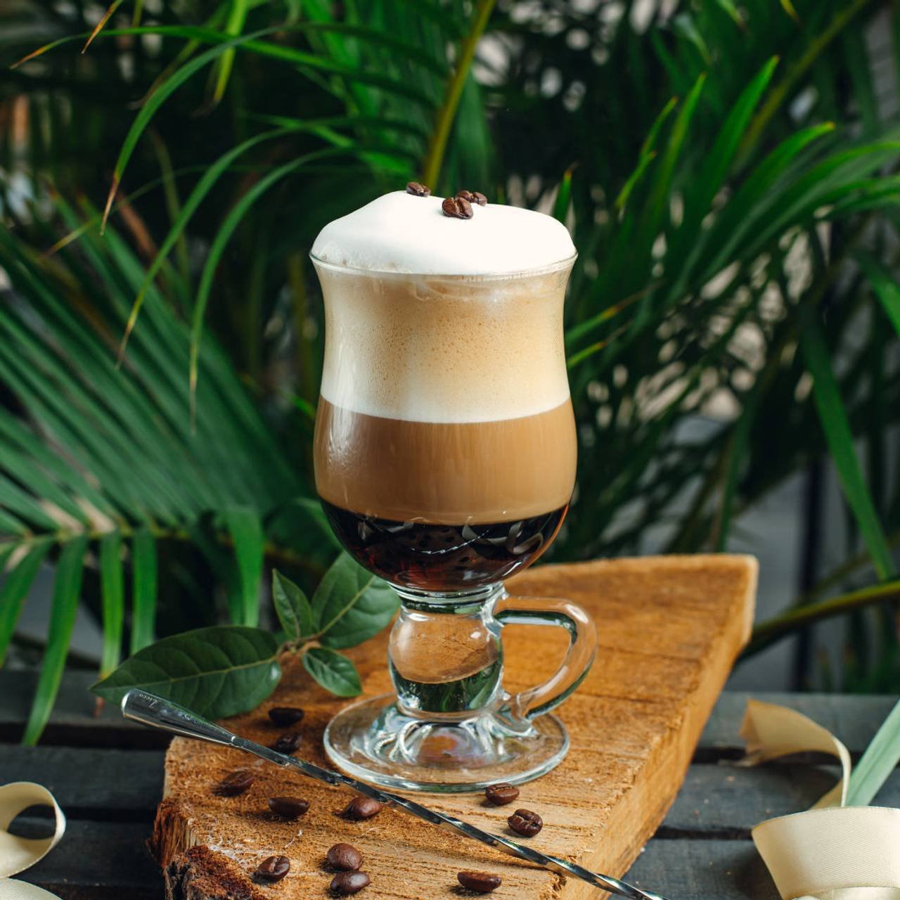 cafe em camadas com creme e graos de cafe na placa de madeira rustica 