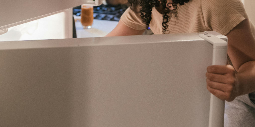 6 Pessoa abrindo a porta da geladeira na cozinha